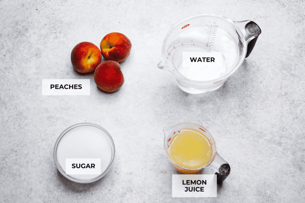 This is the absolute BEST fresh peach lemonade recipe! Sweet juicy peaches combined with tart, tangy lemons make the most refreshing drink. You will want to have a pitcher of this in your fridge throughout the peach season! Overhead shot of labeled ingredients.